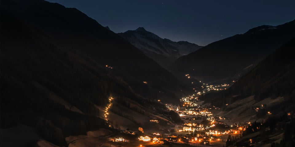 Bright-village-in-valley-dark-evening